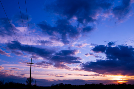 Vivid color clouds on sunset  landscape.  Blue sky with bright pink, yellow and purple.の写真素材