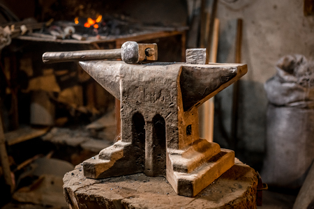 Old blacksmiths hammer on anvil in workshop read to be used for forging iron.の写真素材