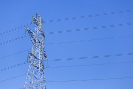 Close up high voltage power lines station. Silhouette of high voltage electric transmission pylonの写真素材