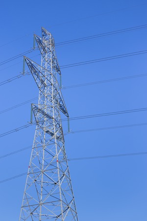 Close up high voltage power lines station. Silhouette of high voltage electric transmission pylonの写真素材