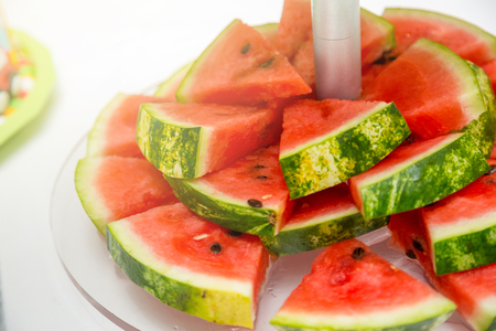 Slice of watermelon on the white plate close up.の写真素材