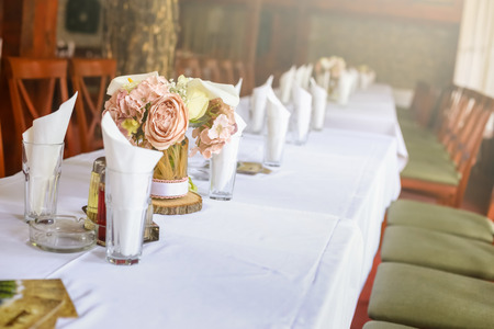 Roses on a festive wedding table in the restaurant. Wedding decoration.の写真素材