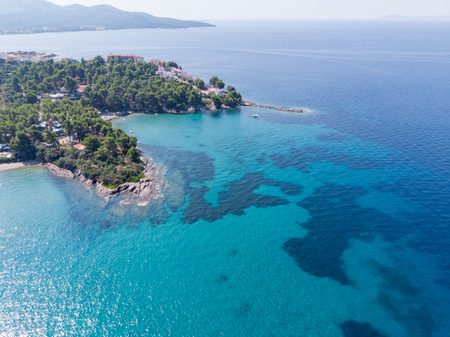 Drone aerial view of sea shore on stones and blue water.の写真素材