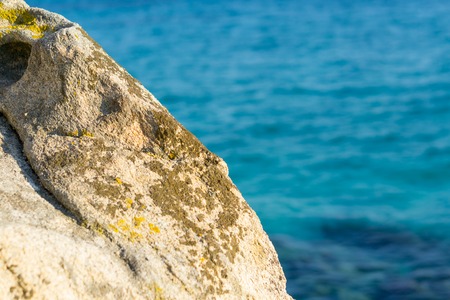Stone in front of sea water on sunny day.の写真素材