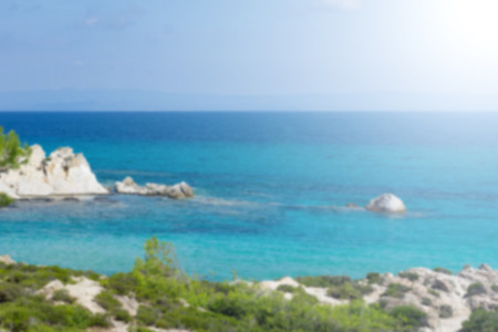 Sunny day on Orange beach of halkidiki, greece. Blurred beach with clear turquoise blue water.