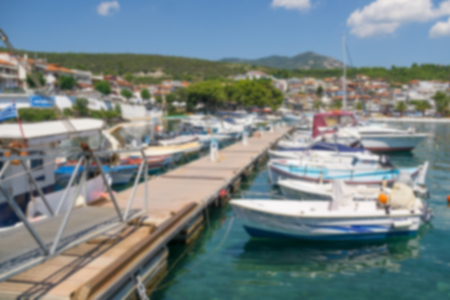 A lot of small boats anchored in a port in town.の写真素材