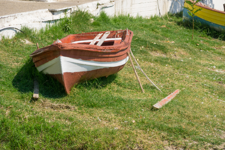 Small old white brown boat on green grass.の写真素材
