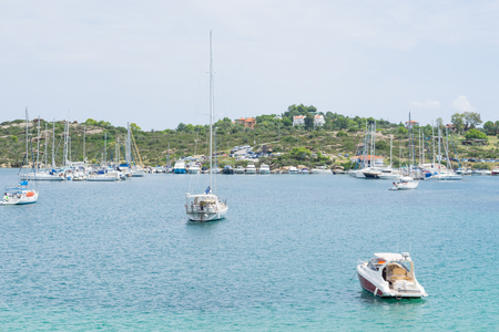 A lot of sailboats anchored in a port outside the city.のeditorial素材