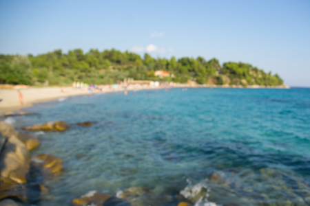 Blue sea water and sandy beach with trees. Blurredの写真素材