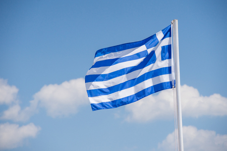 White blue Greece flag on white pylon with blue sky with cloud.の写真素材