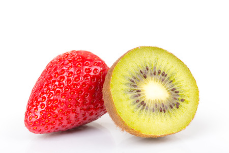 Red fresh strawberries and green kiwi cut into half arranged on a white background.の写真素材