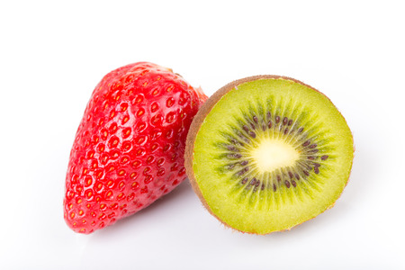 Red fresh strawberries and green kiwi cut into half arranged on a white background.の写真素材