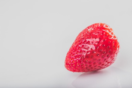 Close up detail of red fresh strawberries on white background.の写真素材