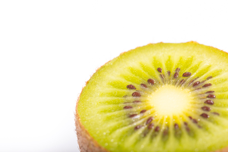Close up detail of green fresh kiwi fruit on white background.の写真素材