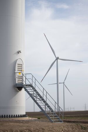 Close up of stairs and door of Wind turbine with two turbines in backgroundの写真素材
