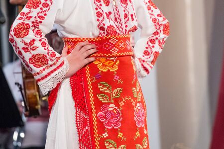 Close up of hands of young Romanian dancers perform a folk dance in traditional folkloric costume. Folklore of Romaniaの写真素材