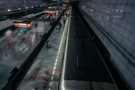 Prague, Czech Republic,23 July 2019; People at metro station entering subway train or walking by, long exposure technique for movement. Urban scene, city life, public transport and traffic concept.のeditorial素材