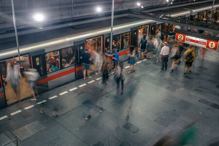 Prague, Czech Republic,23 July 2019; People at metro station entering subway train or walking by, long exposure technique for movement. Urban scene, city life, public transport and traffic concept.のeditorial素材