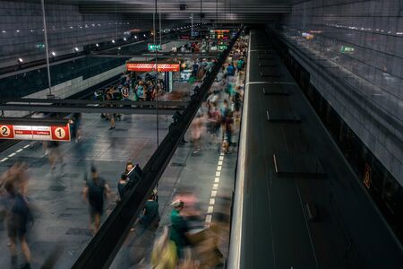 Prague, Czech Republic,23 July 2019; People at metro station entering subway train or walking by, long exposure technique for movement. Urban scene, city life, public transport and traffic concept.のeditorial素材