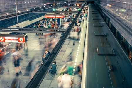 Prague, Czech Republic,23 July 2019; People at metro station entering subway train or walking by, long exposure technique for movement. Urban scene, city life, public transport and traffic concept.のeditorial素材