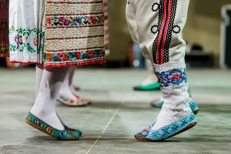 Close up of wool socks on legs of young Romanian female and male dancers in traditional folkloric costume. Folklore of Romaniaの写真素材