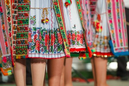 Close up of legs of young Romanian female dancers in traditional folkloric costume. Folklore of Romaniaの写真素材