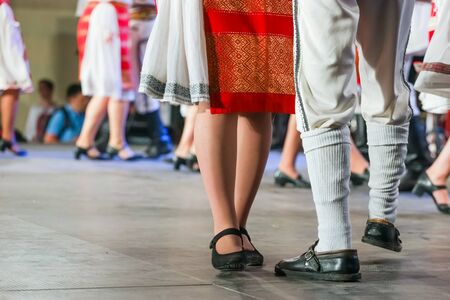 Close up of legs of young Romanian female and male dancers in traditional folkloric costume. Folklore of Romaniaの写真素材