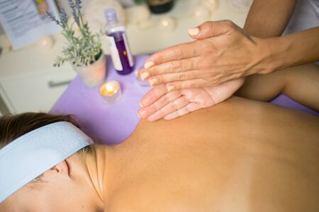 Female relaxing back massage with hands. Beauty body skin care treatment concept.の写真素材