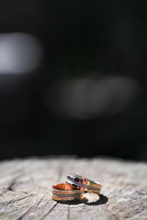Macro close up of two wedding rings on woodの写真素材
