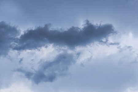 Dark rainy clouds with one even darker part in the middleの写真素材