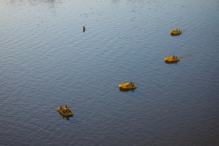 Prague, Czech Republic - Juli 24, 2019: Four yellow pedal boats on Vltava river in Pragueのeditorial素材