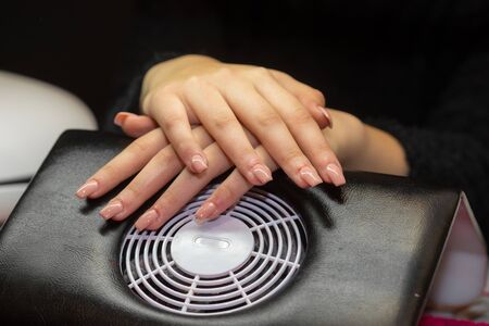 Women hands crossed in nail salonの写真素材