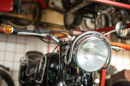 Pancevo, Serbia - September 27, 2019: Front light of Old timer motorcycle parked in collectors museum.のeditorial素材