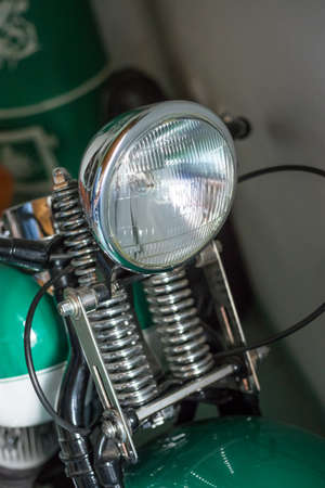 Pancevo, Serbia - September 27, 2019: Front light of Old timer motorcycle parked in collectors museum.のeditorial素材