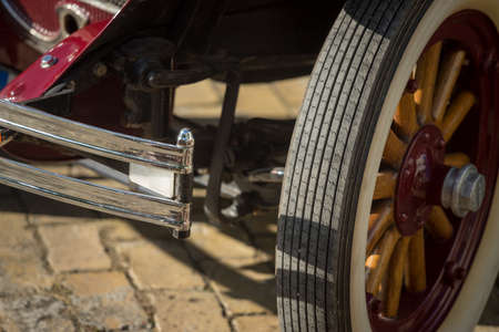 Pancevo, Serbia - September 27, 2019: Front wheel of red vintage 1928 Pontiac car parked in...