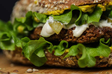 Close up of juicy healthy vegetarian burger on wooden plateの写真素材