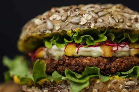 Close up of juicy healthy vegetarian burger on wooden plateの写真素材
