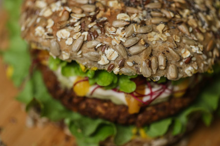 Close up of juicy healthy vegetarian burger on wooden plateの写真素材