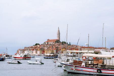 Rovinj, Croatia - July 26, 2014: Panoramic view on old town Rovinj from harbor. Istria peninsula, Croatia. Small boats inside crowded harbor of an old Venetian town harbor, Rovinj, Croatia.のeditorial素材