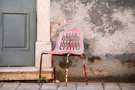 Old doors house with chair. Old vintage entrance doors with chair in front of entrance.の写真素材