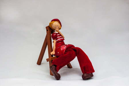 Ceramic doll on a wooden easel on a white backgroundの写真素材