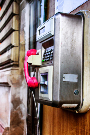 Telephone booth inside with pink headset