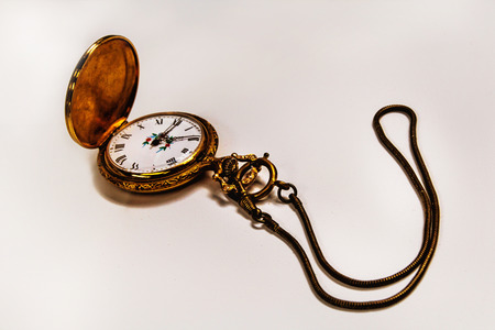 The gilded old pocket watch on a white backgroundの写真素材