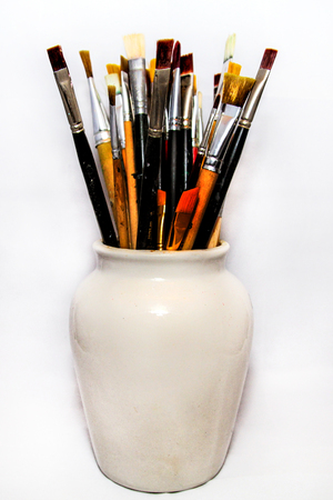 Brushes for painting in a white ceramic bowlの写真素材