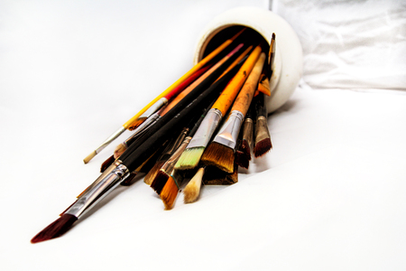 Brushes for painting in a white ceramic bowlの写真素材