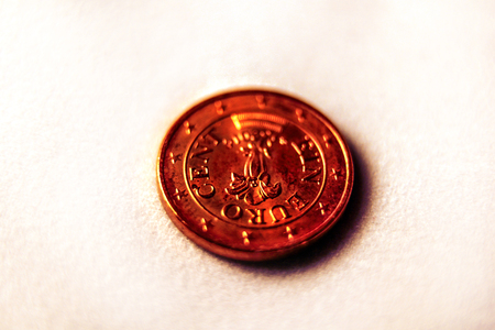 Cash coins of one euro cent with white background, close-up