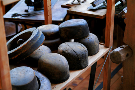 Antique wooden oval molds hat on a wooden shelfの写真素材