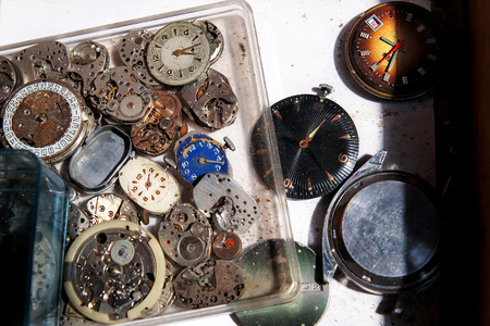 Old clocks and parts clockworks in drawersの写真素材