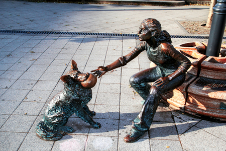 Budapest, Hungary - October 30, 2016: Street sculptures. Statue of girl with dogのeditorial素材