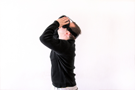 Man using a virtual glasses on white background. Young male business executive using virtual reality...